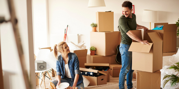 Image of couple unpacking boxes in new house