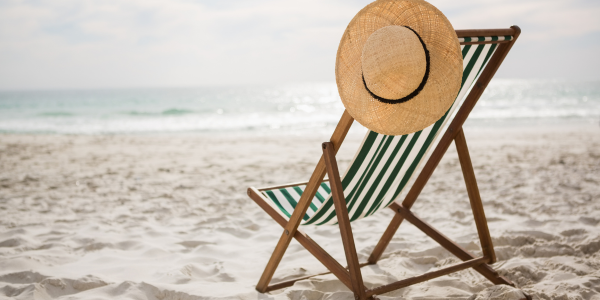 Sunlounger and sun hat on the beach